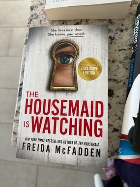 The Housemaid Is Watching by Freida McFadden - White & Red Cover